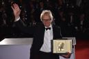 British director Ken Loach poses with his trophy on May 22, 2016 during a photocall after winning the Palme d'Or for the film "I, Daniel Blake" at the 69th Cannes Film Festival in Cannes, southern France