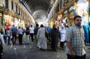 Syrians shop in the covered market in central Damascus on July 9, 2013