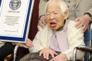 Misao Okawa receives a certification from an official of Guinness World Records in Osaka, Japan