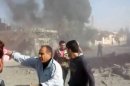 This image taken from video obtained from Shaam News Network, which has been authenticated based on its contents and an Associated Press journalist who saw a plane bomb an area around the Syrian-Turkish border town of Ras al-Ayn, shows Syrians inspecting the damage and looking for victims moments after an airstrike by Syrian warplanes in Ras al-Ayn, Syria, Monday, Nov. 12, 2012. (AP Photo/Shaam News Network via AP video)