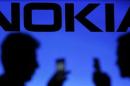 A photo illustration of men silhouetted against a Nokia logo