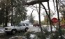 A vehicle drives under a fallen tree that hangs over a road, in Wilbraham, Mass., Monday, Oct. 31, 2011. Snow and high winds from a rare late October storm over the weekend brought down trees and tree limbs across the state, damaging power lines and leaving many without electricity. (AP Photo/Steven Senne)