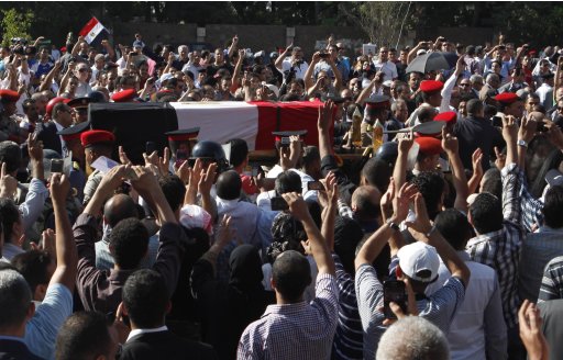 Supporters of Egypt's former intelligence chief Suleiman gather around his casket in Heliopolis