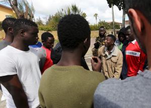 Adolescent migrants argue during a protest in a courtyard &hellip;