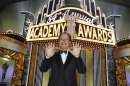 Billy Crystal pauses for a picture showing nine fingers for the number of times he's hosted the show after the 84th Academy Awards on Sunday, Feb. 26, 2012, in the Hollywood section of Los Angeles. (AP Photo/Chris Carlson)