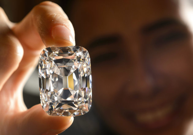 FILE- In this Oct. 4, 2012, file photo, a model holds the Archduke Joseph Diamond, a historical diamond, during a Christie's auction preview, in Geneva, Switzerland. On Tuesday, Nov. 13, 2012 Christie’s is selling the Archduke Joseph Diamond, one of the rarest and most famous. The 76.02 carat diamond, with perfect color and internally flawless clarity, came from the ancient Golconda mines in India. It is expected to sell for more than $15 million. In 1993, Christie’s auctioned it in Geneva where it sold for $ 6.5 million. (AP Photo/Keystone, Laurent Gillieron, File)
