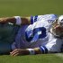 Dallas Cowboys quarterback Tony Romo (9) lays on the ground after being hit by San Francisco 49ers cornerback Carlos Rogers  in the second quarter of an NFL football game in San Francisco, Sunday, Sept. 18, 2011. (AP Photo/Marcio Jose Sanchez)
