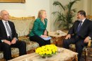 In this photo released by the Egyptian Presidency, U.S. Secretary of State Hillary Rodham Clinton, center, meets with Egyptian President Mohammed Morsi, right, and Egyptian Foreign Minister Mohammed Kamel Amr, left, in Cairo, Egypt, Wednesday, Nov. 21, 2012. Secretary of State Hillary Rodham Clinton has arrived in Cairo in her diplomatic push to forge a truce between Israel and Gaza rulers of Hamas. Her visit comes hours after a bomb exploded on an Israeli bus in Tel Aviv, wounding several. Clinton is looking to piece together a deal to end Israel's weeklong offensive in the Gaza Strip. Clinton said the U.S. "strongly condemns" today's bus bombing, calling it a "terrorist attack." (AP Photo/Egyptian Presidency)
