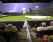 A lightning bolt strikes in the distance as spectators wait for the storm to blow over at TD Ameritrade Park in downtown Omaha, Neb., Monday, June 20, 2011, where Vanderbilt and Florida were playing i