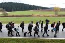 Migrants on the road after crossing the Austrian-German border near the Bavarian village of Wegscheid, southern Germany on November 9, 2015