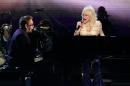 FILE - This Nov. 15, 2005 file photo shows Elton John, left, and Dolly Parton performing at the 39th Annual Country Music Association Awards in New York. The 47th annual awards, hosted by Carrie Underwood and Brad Paisley, airs Wednesday, Nov. 6, 2013. (AP Photo/Julie Jacobson, File)
