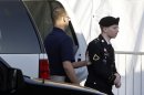 Army Pfc. Bradley Manning, right, is escorted from a security vehicle to a courthouse in Fort Meade, Md., Wednesday, April 10, 2013, before a pretrial military hearing. Manning, who is charged with causing hundreds of thousands of classified documents to be published on the secret-sharing website WikiLeaks, is scheduled to face a court martial in June. (AP Photo/Patrick Semansky)