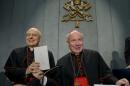 Cardinals Lorenzo Baldisseri, left, and Christoph Schoenborn show a copy of the post-synodal apostolic exhortation ' Amoris Laetitia ' (The Joy of Love) during a press conference at the Vatican, Friday, April 8, 2016. Pope Francis has insisted that individual conscience be the guiding principle for Catholics negotiating the complexities of sex, marriage and family life in a major document released Friday that repudiates the centrality of black and white rules for the faithful. In the 256-page document "The Joy of Love," released Friday, Francis makes no change in church doctrine. (AP Photo/Andrew Medichini)