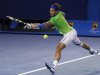 Nadal of Spain hits a return to Federer of Switzerland during their semi-final match at the Australian Open in Melbourne