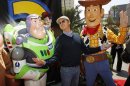 Actor Keaton poses with characters Buzz Lightyear and and Woody at world premiere of Disney Pixar's "Toy Story 3" in Hollywood
