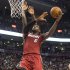 Miami Heat's LeBron James scores on Toronto Raptors' Amir Johnson during first half NBA basketball action in Toronto on Sunday, March 17, 2013. (AP Photo/THE CANADIAN PRESS,Chris Young)