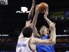 Dallas Mavericks forward Dirk Nowitzki, right, shoots as Oklahoma City Thunder center Nick Collison (4) defends in the first quarter of Game 1 in a first-round NBA basketball playoff series in Oklahoma City, Saturday, April 28, 2012. (AP Photo/Sue Ogrocki)
