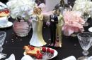 Same-sex couple plastic figurines are displayed during a gay wedding fair in Paris