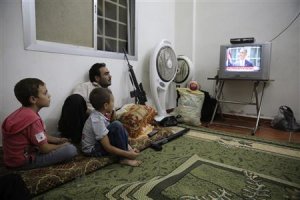 A Free Syrian Army fighter watches U.S. President Barack …