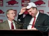 Arkansas athletic director Jeff Long, left, presents Bret Bielema with a cap as Bielema is introduced as the school's new head coach during an NCAA college football news conference in Fayetteville, Ark., Wednesday, Dec. 5, 2012. Bielema, who will be paid $3.2 million annually for six years, replaces interim coach John L. Smith, who was hired after Bobby Petrino was fired in April. (AP Photo/April L. Brown)