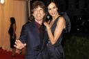 FILE - This May 7, 2012 file photo shows singer Mick Jagger, left, and L'Wren Scott at the Metropolitan Museum of Art Costume Institute gala benefit, celebrating Elsa Schiaparelli and Miuccia Prada, in New York. Scott, a fashion designer, was found dead Monday, March 17, 2014, in Manhattan of a possible suicide. (AP Photo/Evan Agostini, File)