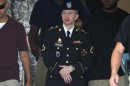 U.S. Army Pfc. Bradley Manning is escorted out of a courthouse at Fort Meade in Maryland, July 18, 2013.