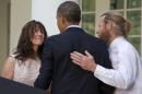 Parents of U.S. Army Sgt. Bowe Bergdahl, Jani Bergdahl, left, and Bob Bergdahl, turn to President Barack Obama after he spoke in the Rose Garden of the White House in Washington, Saturday, May 31, 2014, after the announcement that Bowe Bergdahl has been released from captivity in Afghanistan. Bergdahl, 28, had been held prisoner by the Taliban since June 30, 2009. He was handed over to U.S. special forces by the Taliban in exchange for the release of five Afghan detainees held by the United States. (AP Photo/Jacquelyn Martin)