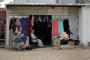 a Bedouin woman sits in                  her store in Hura