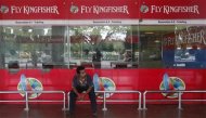 An airlines staff member sits in front of a closed Kingfisher Airlines ticketing counter at the airport in Kolkata October 3, 2012. REUTERS/Rupak De Chowdhuri/Files