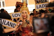 A fan of US pop diva Lady Gaga arrives at Bangkok's Don Mueang airport in May 2012. First she made a joke about buying a fake rolex. Now Thailand's culture ministry has filed a complaint to police against Lady Gaga for misuse of the Thai flag during her show last month