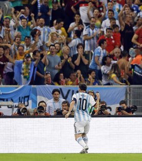 Lionel Messi pumps his first in jubilation as Argentina fans cheer him on. (AP)