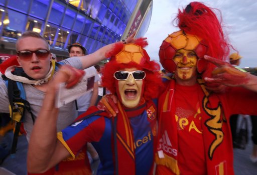 Fans of Spain cheer before Euro 2012 semi-final soccer match against Portugal at the Donbass Arena in Donetsk