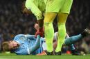 Manchester City's midfielder Kevin De Bruyne (L) reacts as he talks with Everton's goalkeeper Joel Robles before being stretchered off during an English League Cup semi-final match at the Etihad Stadium in Manchester on January 27, 2016