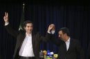 In this picture taken on Saturday, May 11, 2013, Iranian President Mahmoud Ahmadinejad, right, joins hands with his close ally Esfandiar Rahim Mashaei, as he flashes a victory sign, at the start of their press conference, after registering the candidacy of Mashaei for the upcoming presidential election, at the election headquarters of the interior ministry, in Tehran, Iran. By now, President Mahmoud Ahmadinejad is well accustomed to enduring blows from Iran's ruling clerics as his reputation fell from favored son to political outcast. But their intended parting shot _ barring his chief aide from the presidential race _ may be just the opening act in Ahmadinejad's reinvention as a self-styled opposition force. (AP Photo/Ebrahim Noroozi)