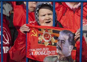 An elderly Russian Communist party supporter holds …