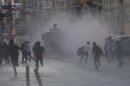 Riot police use a water cannon to disperse protesters in central Istanbul