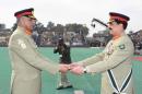 Pakistan's outgoing Army Chief Gen. Raheel Sharif (R) hands over a ceremonial baton to his successor Gen. Qamar Javed Bajwa during the Change of Command ceremony in Rawalpind