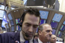 In a Feb. 8, 2012 photo Trader Gregory Rowe, left, works on the floor of the New York Stock Exchange. Wall Street was poised for fairly big losses at the open Wednesday April 4, 2012, with Dow futures and the broader S&P 500 futures 0.7 percent lower. (AP Photo/Richard Drew)