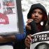 A woman wipes away tears next to a photograph of Trayvon Martin during a rally in support of the slain teenager at Freedom Plaza in Washington, on Saturday, March 24, 2012. Martin, an unarmed young black teen, was fatally shot by a volunteer neighborhood watchman. (AP Photo/Jacquelyn Martin)