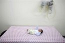 A baby abandoned in a "baby box" at Joosarang church waits for a medical examination at a children's hospital in Seoul