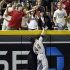 Arizona Diamondbacks fans reach for the ball hit for a home run by Diamondbacks' Justin Upton, over Pittsburgh Pirates left fielder Alex Presely (44) in the sixth inning of an MLB baseball game, Monday, Sept. 19, 2011, in Phoenix. (AP Photo/Paul Connors)