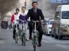 Sebastian Coe, chairman of the London Organizing Committee of the Olympic Games (LOCOG), foreground, rides a bicycle, followed by Chinese athletes Yang Yilin, Gymnastic gold medalist of the 2008 Beijing Olympics, and Lin Furong upon arrival to the British Embassy in Beijing, China, Sunday, Dec. 11, 2011. Coe arrives the embassy to give a press briefing on an update on preparations for the London 2012 Olympics and Paralympic Games. (AP Photo/Andy Wong)