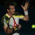 Murray of Britain hits a return to Istomin of Uzbekistan during their men's singles match at the Brisbane International tennis tournament
