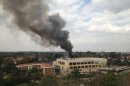 Heavy smoke rises from the Westgate Mall in Nairobi Kenya Monday Sept. 23 2013. Multiple large blasts have rocked the mall where a hostage siege is in its third day. Associated Press reporters on the scene heard multiple blasts and a barrage of gunfire. Security forces have been attempting to rescue an unknown number of hostages inside the mall held by al-Qaida-linked terrorists. (AP Photo/ Jerome Delay)