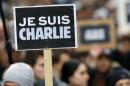 People hold a poster reading "Je suis Charlie (I am Charlie)" during a rally in Paris on January 11, 2015 in tribute to the 17 victims of a three-day killing spree by homegrown Islamists