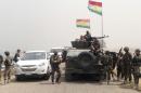 Kurdish fighters stand guard at the Mosul Dam in northern Iraq