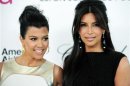 Television personalities sisters Kourtney and Kim Kardashian arrive at the 20th annual Elton John AIDS Foundation Academy Awards Viewing Party in West Hollywood, California