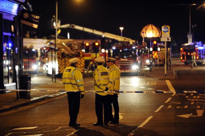 Emergency services gather at the site where a police helicopter crashed into a pub in central Glasgow,shortly after midnight on November 30, 2013