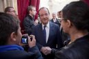 French President Francois Hollande greets visitors in the Elysee presidential palace in Paris