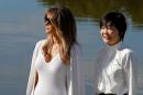 U.S. First Lady Melania Trump and Akie Abe, wife of Japanese Prime Minister Shinzo Abe, listen to a guide as they tour Morikami Museum and Japanese Gardens in Delray Beach